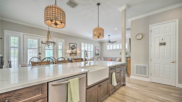 A spacious kitchen with a large island, pendant lighting, and a view to the dining area. - 7 Mi to Disney: Reunion Resort Oasis w/ Pool (Kissimmee)