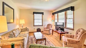A living room with a sofa, armchairs, a coffee table, a TV, and a fireplace. - Charming Aiken Vacation Rental 2 Mi to Dtwn! (Aiken)