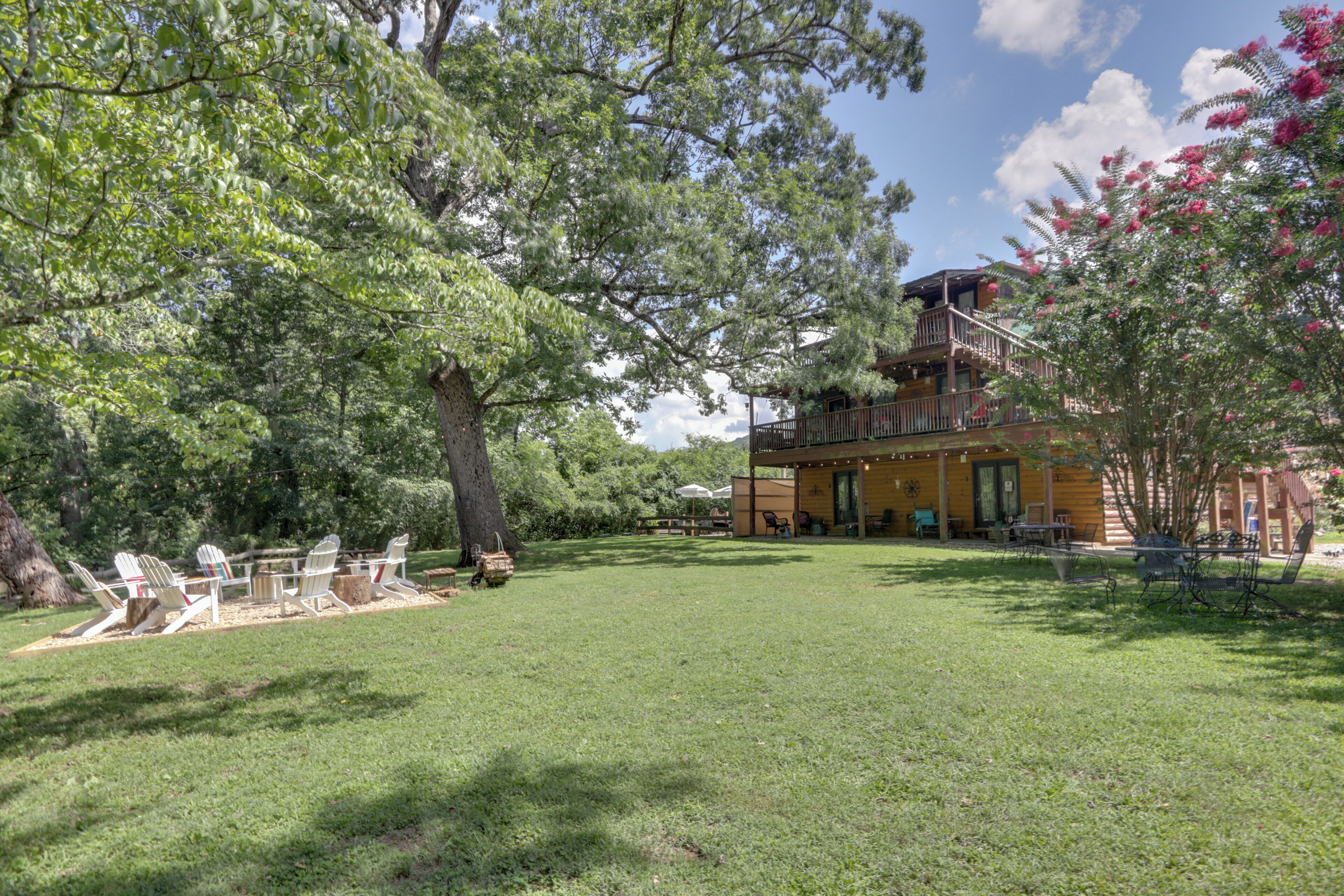 A wooden cabin with a deck and outdoor seating area.