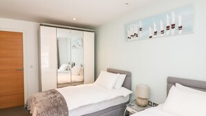 A bedroom with a bed, a nightstand, a wardrobe, and a wall-mounted artwork. - 30 Dart Marina (Dartmouth)