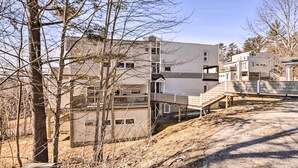Ein mehrstöckiges Haus mit einer überdachten Veranda und einer Treppe zu den oberen Stockwerken.