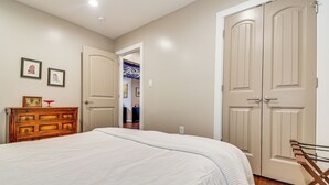 A bedroom with a bed, dresser, and wardrobe. - 2 Mi to Duke & Dtwn Durham: Modern Home w/ Patio! (Durham)