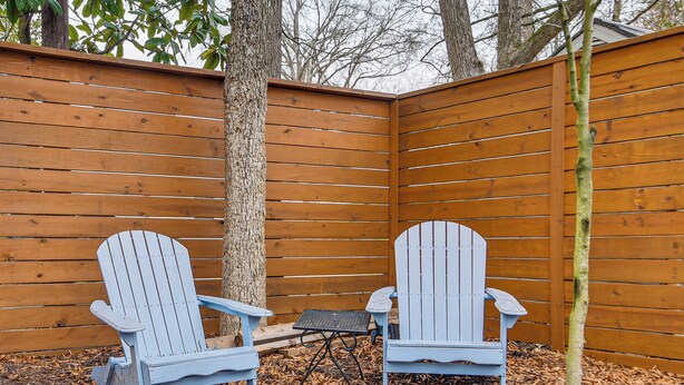 Two Adirondack chairs and a small table in a wooden deck area. - 2 Mi to Duke & Dtwn Durham: Modern Home w/ Patio! (Durham)