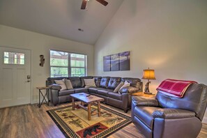 A living room with a sectional sofa, a coffee table, and a rug. - Townsend Condo w/ Pool, Great Smoky Mountain Views (Townsend)
