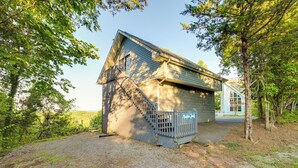 A small, single-story building with a sloped roof and a small porch. - Near Douglas Lake: Mountain Jewel Haven w/ Views (Sevierville)