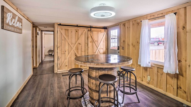 A wooden interior with a round bar table, stools, and a ceiling light. - 'take 5' Retreat w/ Hot Tub: Relax, Rest, Refresh! (Somerset)