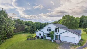 A single-story white house with a green door, a satellite dish, and a small porch. - Burlington Flats House < 13 Mi to Cooperstown! (Burlington Flats)