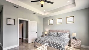 A bedroom with a bed, nightstands, a ceiling fan, and three windows. - Stunning Laguna Vista Retreat w/ Pool & Grill (Port Isabel)