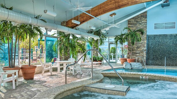 A spa area with a hot tub, lounge chairs, and potted plants. - Private Beach Access: Wildwood Crest Retreat (Wildwood Crest)