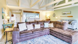 A modern living room with a sectional sofa, a dining area, and a kitchen in the background. - 5 Pools: Pet-friendly Palmetto Dunes Condo! (Hilton Head Island)