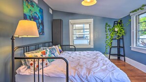 A bedroom with a bed, a window, a lamp, and a painting on the wall. - Bright St Petersburg Home w/ Pergola & Garden (St. Petersburg)