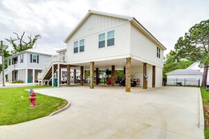 A two-story house with a covered porch and a fire hydrant in the yard.