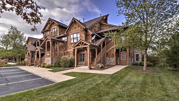 A large, multi-story wooden house with a covered front porch and a driveway. - Spacious Condo w/ View < 1 Mi to Mtn Creek Resort! (Vernon)