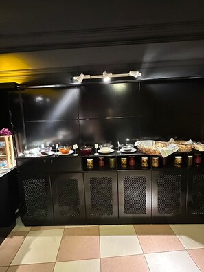 A buffet setup with various food items and condiments. - Sufi Homes (Konya)