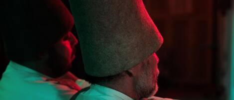 A person wearing a hat with a textured surface.