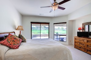A bedroom with a bed, a ceiling fan, a dresser, and a television. - Country Club Home: 2br, 2 BA + Den ~ 1 Mi to Golf! (Borrego Springs)