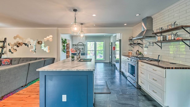 A modern kitchen with a central island, built-in appliances, and a view to the outdoors. - Peaceful Southern Pines Home w/ Pool + Yard! (Southern Pines)