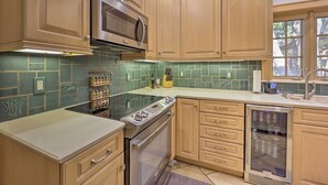 A kitchen with wooden cabinets, a stainless steel oven, a microwave, and a dishwasher. - 10 Mi to Grand Lake: Home w/ Game Room in Jay! (Jay)