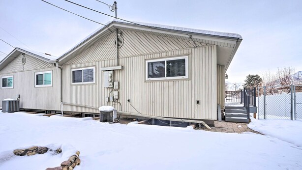 A single-story mobile home with a pitched roof, a front porch, and a small attached garage.