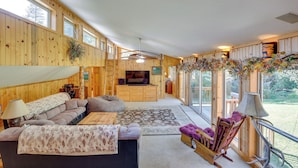 A spacious wooden cabin interior with a sofa, a TV, and a dining area. - Horse Tours + Wildlife: Boise Ranch Home w/ Pool! (Boise)