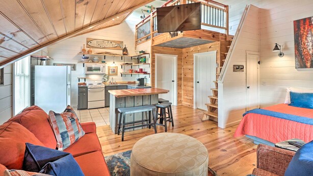 A cozy loft-style room with a wooden ceiling, a kitchen area, a dining space, and a bedroom with a bed and a window. - Mountain View Escape - 1 Mile to White River! (Mountain View)