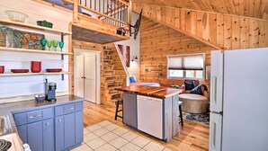 A kitchen with wooden walls, a wooden island, a dishwasher, and a refrigerator. - Mountain View Escape - 1 Mile to White River! (Mountain View)