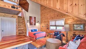 A cozy cabin with a loft bedroom, a dining area, and a living room with a fireplace. - Mountain View Escape - 1 Mile to White River! (Mountain View)