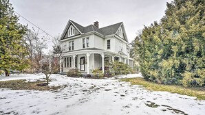 A large, two-story house with a prominent porch and a well-maintained lawn. - Spacious Getaway: 7 Mi to Whitetail Slopes! (Mercersburg)