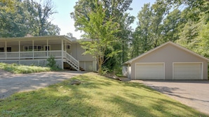 A two-story house with a covered porch and a garage. - Harpers Ferry Cabin - Walk to Private Lake! (Harpers Ferry)
