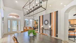 A spacious dining area with a large table, chairs, and a modern chandelier. - Clermont Vacation Rental w/ Pool: 11 Mi to Disney (Clermont)
