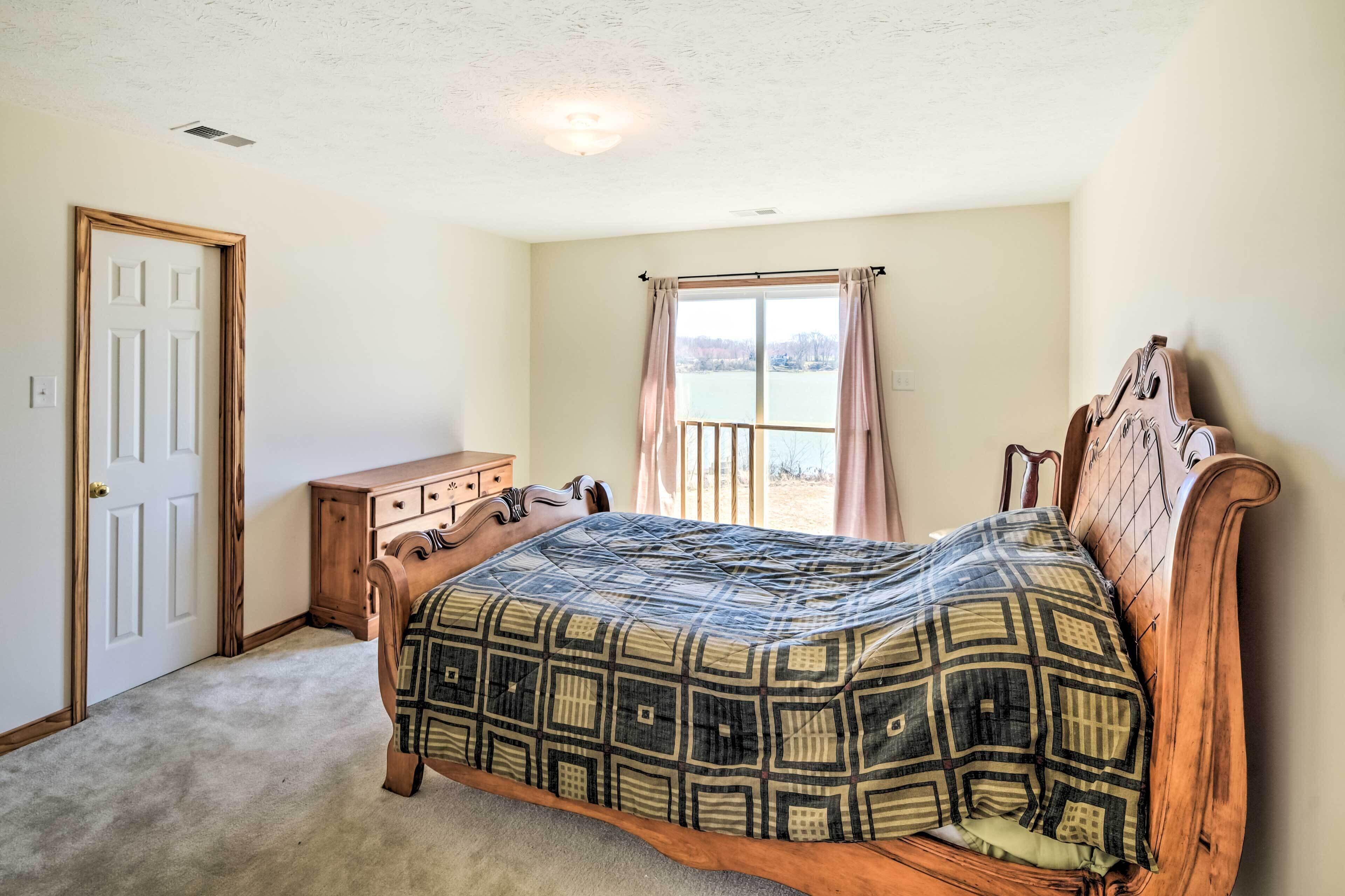 Une chambre à coucher avec un lit en bois, une commode et une fenêtre avec des rideaux.