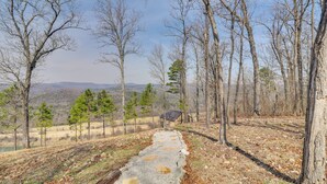 A gravel path leading through a forested area with a small cabin in the distance. - Peaceful Mountain Air Getaway w/ Fire Pit! (Mountain View)