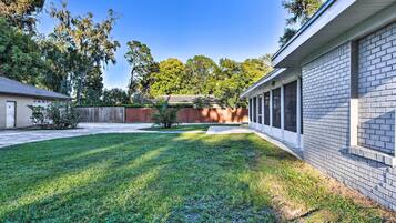 Enjoy an outdoor space with a well-maintained lawn and a covered porch.
