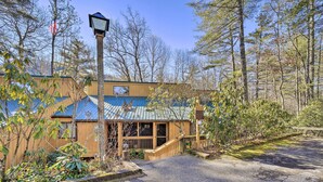 A building with a blue roof, wooden exterior, and a porch with a wooden railing. - Sunny Sapphire Townhome w/ Resort Amenities! (Sapphire)