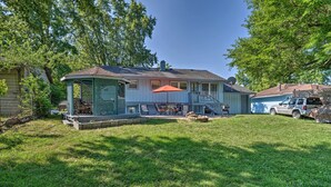 A house with a covered patio, a fenced yard, and a vehicle parked in the driveway. - Home w/ Fire Pit - 8 Mi to Dtwn Mile Square! (Indianapolis)
