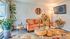 A living room with a sofa, coffee table, and decorative items. - Home w/ Fire Pit - 8 Mi to Dtwn Mile Square! (Indianapolis)