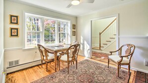 A dining area with a table and chairs, a patterned rug, and a ceiling fan. - 20 Mi to Philly: Inviting Home w/ Yard in Wayne! (Wayne)