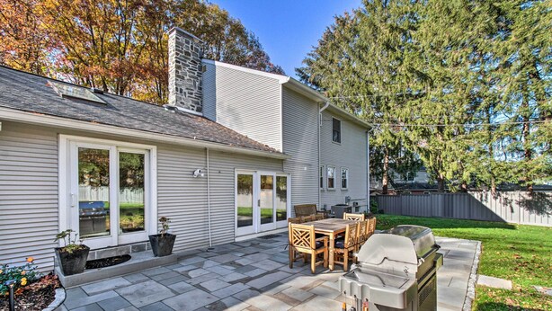 A house with a patio, a barbecue grill, and a stone fireplace. - 20 Mi to Philly: Inviting Home w/ Yard in Wayne! (Wayne)