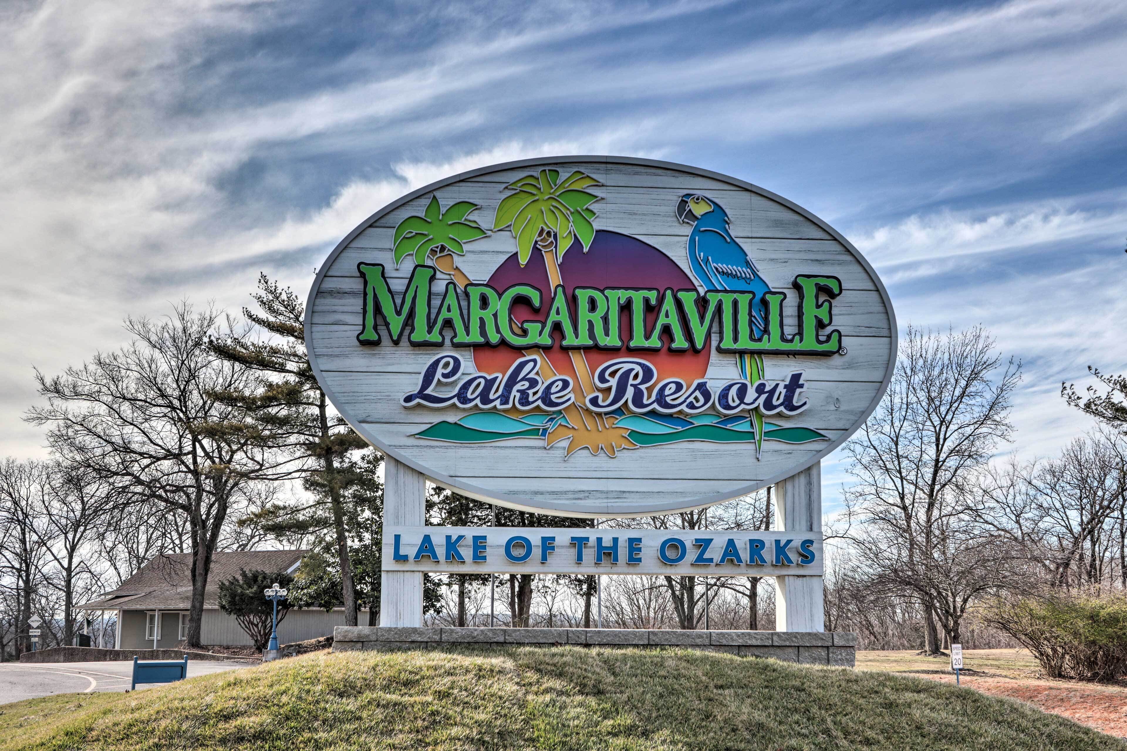 Señal de Margaritaville Lake Resort con palmeras y un loro.
