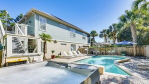 A backyard with a swimming pool, lounge chairs, and a hot tub. - Santa Rosa Beach Home w/ Pool, Hot Tub & Deck! (Santa Rosa Beach)