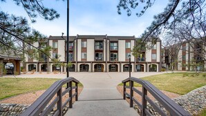 A multi-story building with a central courtyard, featuring a stone pathway leading to the entrance. - Grand Junction Vacation Rental: Indoor Pool Access (Grand Junction)