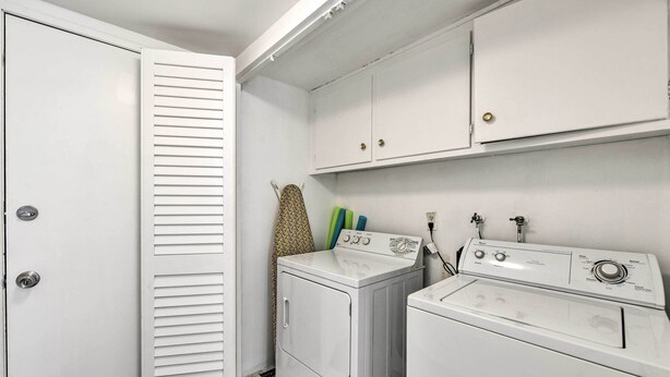 A laundry room with two washing machines, a dryer, and a white door with louvered glass panels. - Furnished Patio + Pool Access: Palm Springs Condo (Palm Springs)