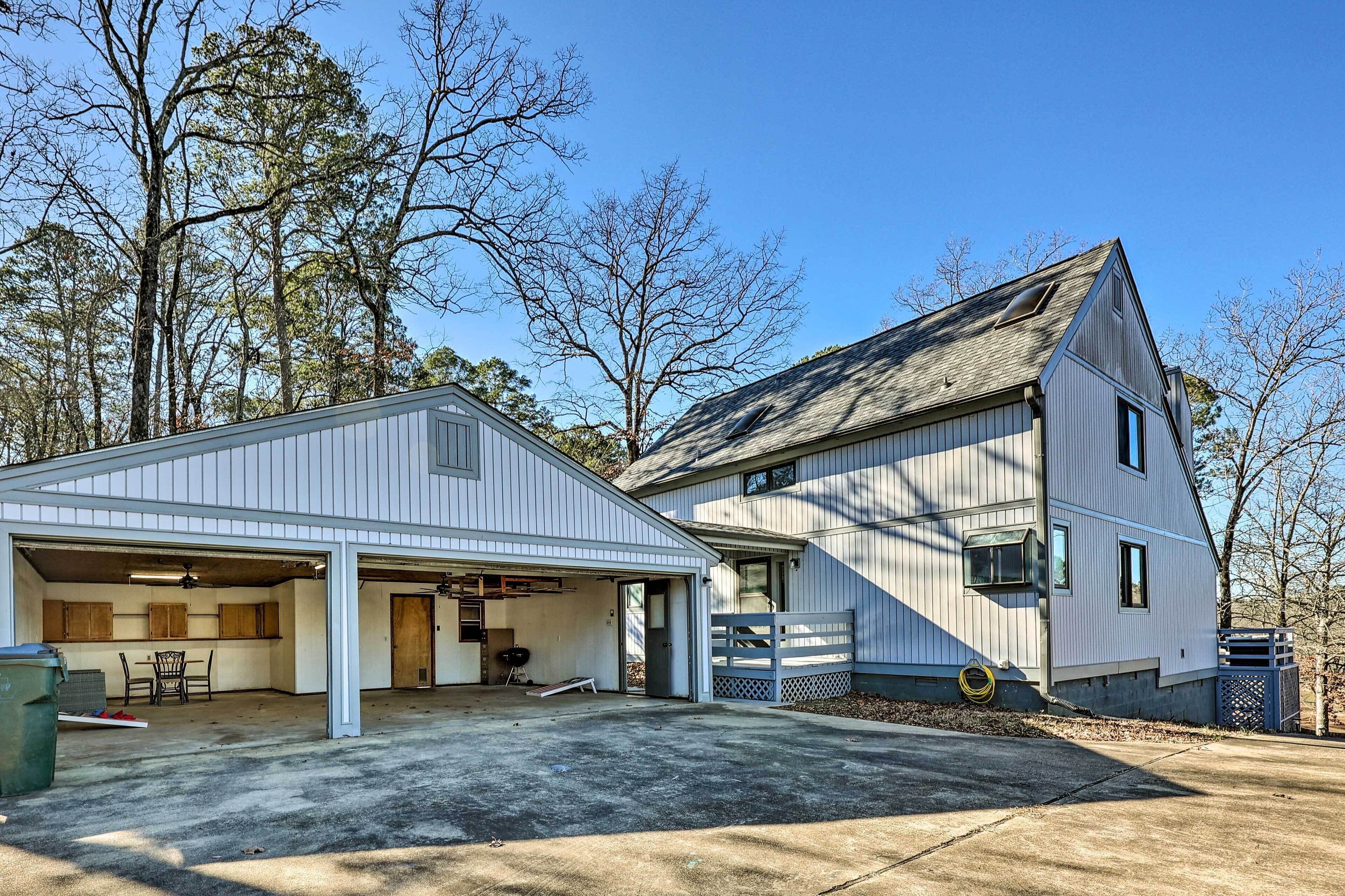 A two-story house with a garage and a covered patio area.