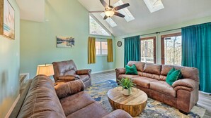 A spacious living room with leather sofas, a coffee table, and a ceiling fan. - Near Ouachita River: Home w/ Deck in Hot Springs (Hot Springs)