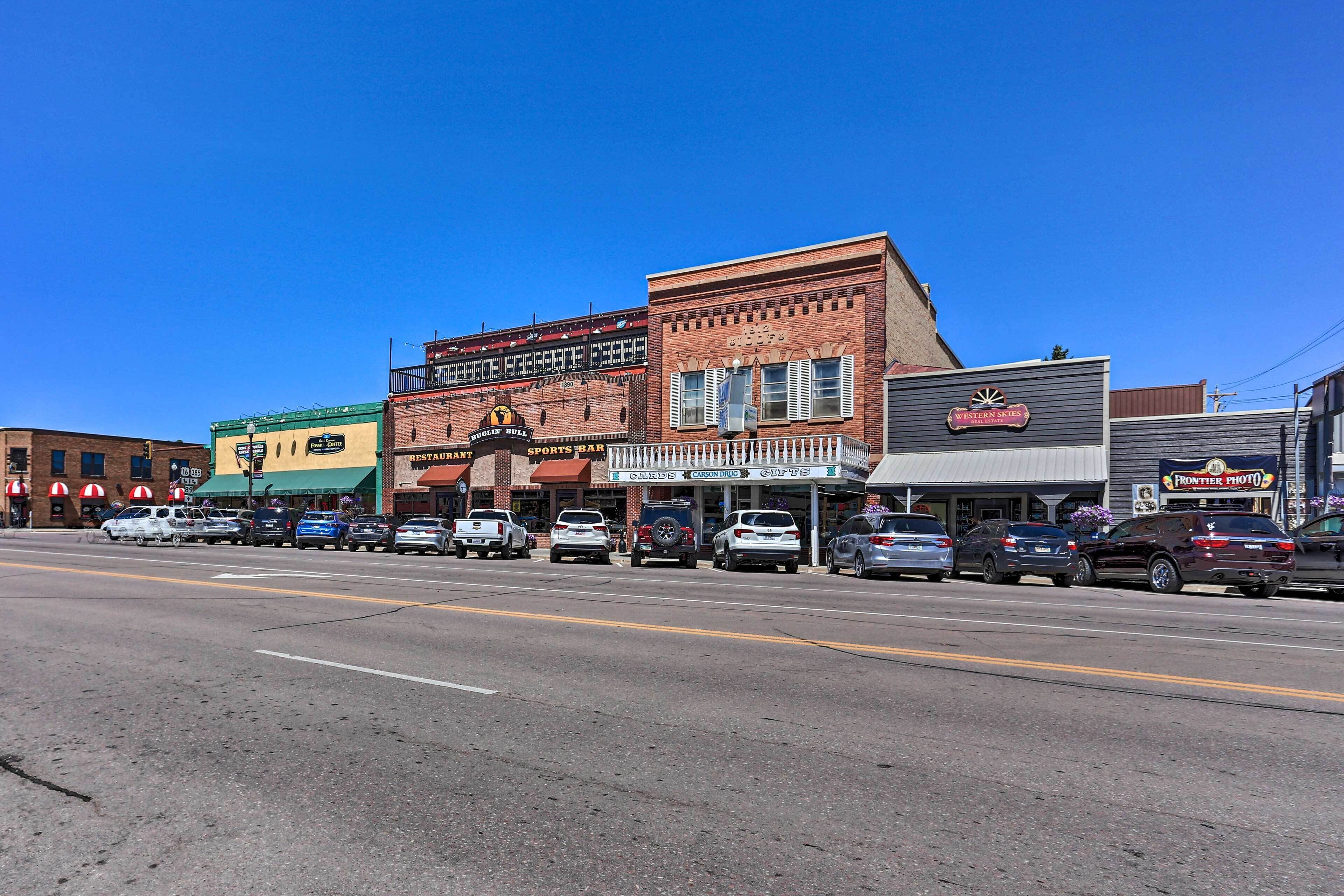 A street view with various storefronts, including a Western Skies restaurant and a Frontier Photo shop.