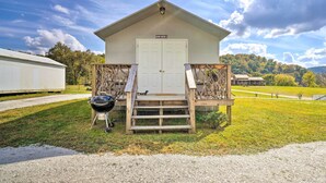 A rustic cabin with a wooden porch, a grill, and a sign reading "BUNK HOUSE B". - Dog-friendly Huntsville Home, ATV Authorized Route (Huntsville)