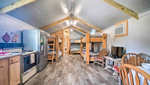A compact kitchen with modern appliances, wooden furniture, and a herringbone-patterned floor. - Dog-friendly Huntsville Home, ATV Authorized Route (Huntsville)
