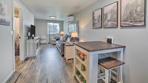 Ein modernes Wohnzimmer mit einer Couch, einem Couchtisch und Kunstwerken an der Wand.