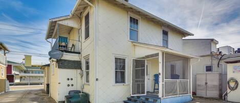 A two-story house with a porch, a satellite dish, and a garage.