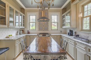 A spacious kitchen with a large island, white cabinetry, and a decorative backsplash. - Family Laurinburg Home w/ Private Yard & BBQ (Laurinburg)